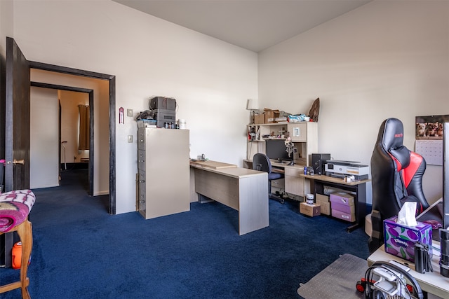 office featuring vaulted ceiling and dark carpet