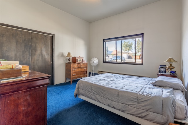 bedroom featuring dark carpet