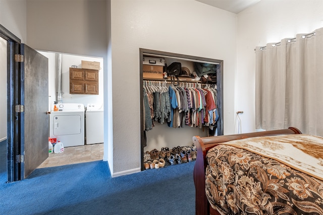 carpeted bedroom with a closet and washer and dryer