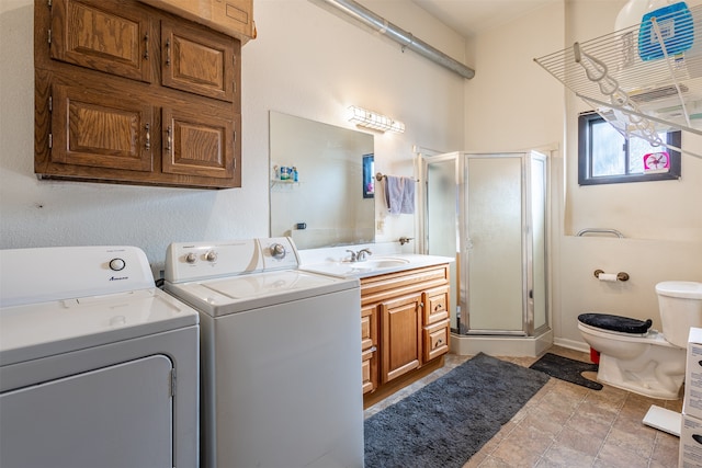 laundry room featuring laundry area, separate washer and dryer, and a sink