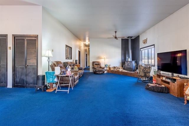 interior space featuring a ceiling fan and a wood stove