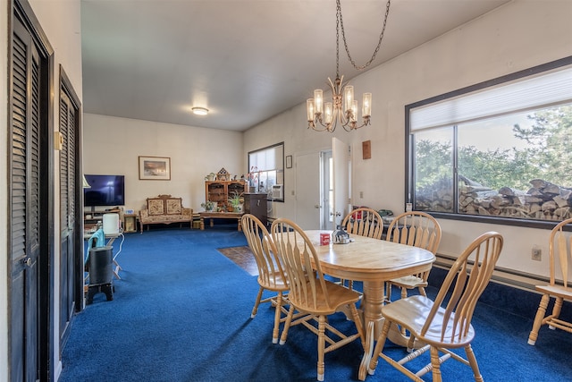 carpeted dining room featuring an inviting chandelier