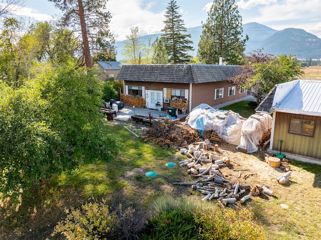 back of property with a mountain view