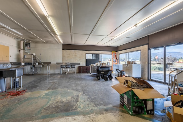 misc room featuring unfinished concrete flooring and heating unit