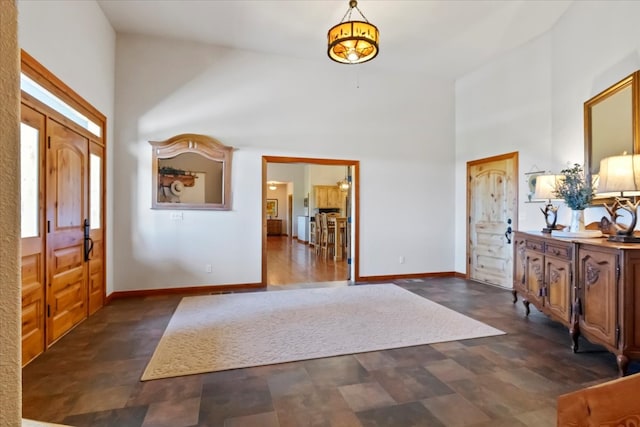 foyer featuring a towering ceiling