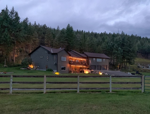 exterior space with a front lawn, a rural view, and a deck