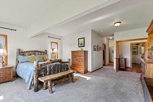 bedroom featuring beamed ceiling and carpet floors