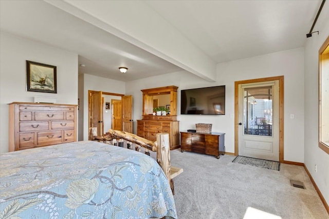 carpeted bedroom with beam ceiling