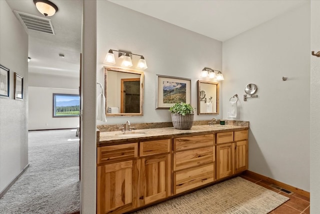 bathroom with tile patterned flooring and vanity