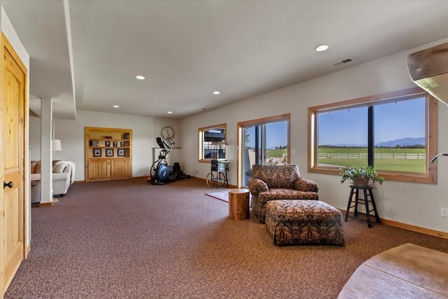 living area featuring a mountain view and carpet