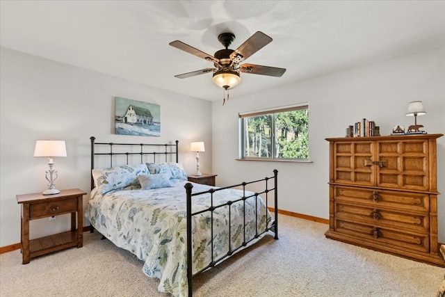 bedroom with ceiling fan and light carpet