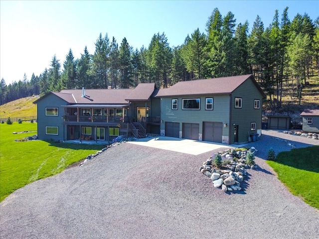 view of front facade with a garage and a front lawn