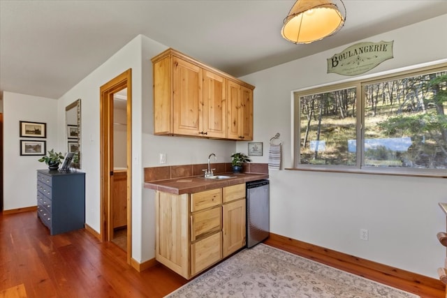 kitchen featuring light brown cabinetry, sink, tile countertops, dishwasher, and dark hardwood / wood-style floors