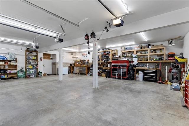 garage with a workshop area and a garage door opener