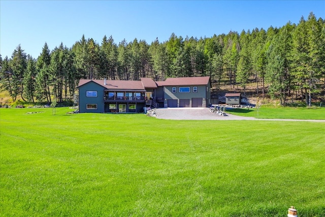 view of front of property featuring a garage and a front lawn