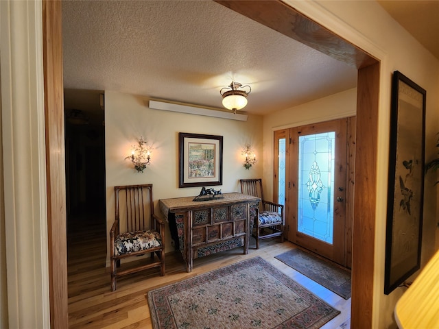 foyer featuring a textured ceiling and hardwood / wood-style floors