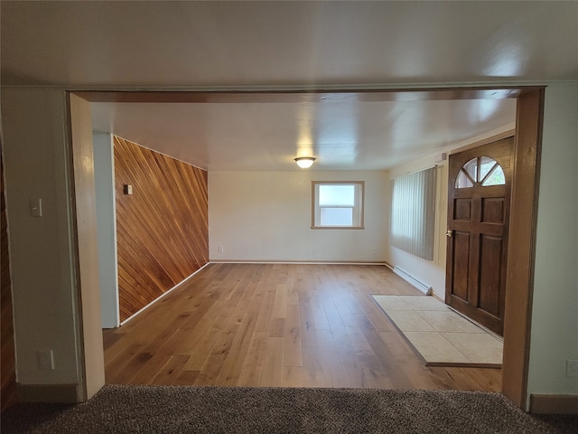 foyer entrance featuring a baseboard radiator and light hardwood / wood-style flooring