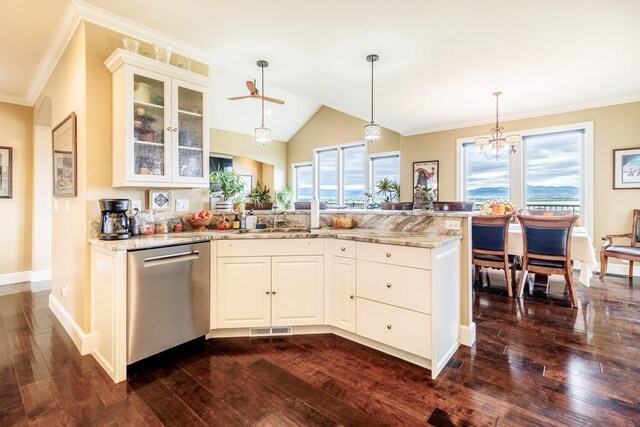 kitchen with dark wood-type flooring, light stone counters, dishwasher, decorative light fixtures, and sink