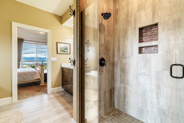 bathroom featuring walk in shower, vanity, and hardwood / wood-style floors