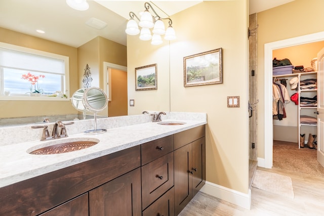 bathroom with vanity, a chandelier, and hardwood / wood-style flooring