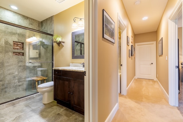 bathroom with vanity, toilet, and an enclosed shower