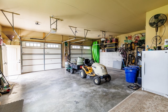 garage featuring a garage door opener and white refrigerator