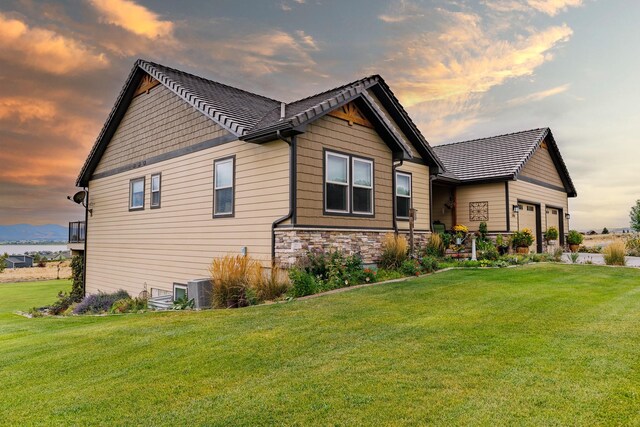 property exterior at dusk with a yard