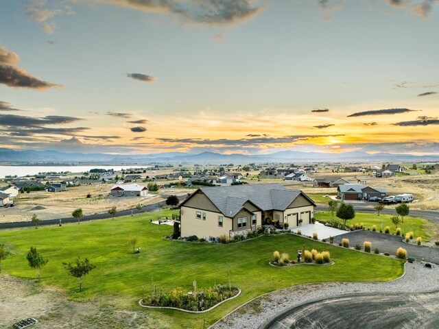 aerial view at dusk featuring a mountain view