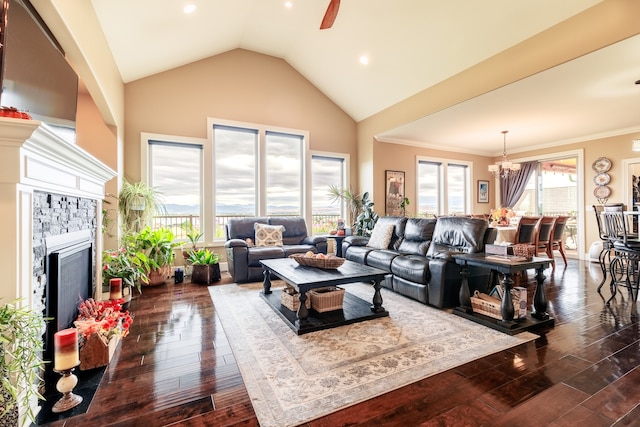 living room featuring ceiling fan with notable chandelier, dark hardwood / wood-style floors, ornamental molding, and high vaulted ceiling