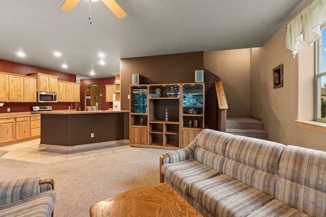 living room with ceiling fan and light colored carpet