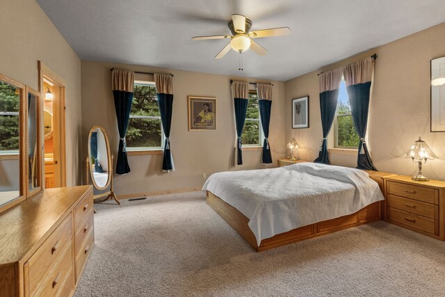 carpeted bedroom featuring ceiling fan