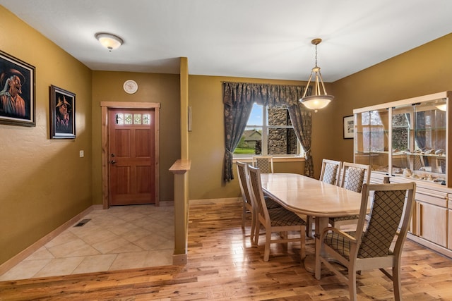 dining area featuring light wood-type flooring