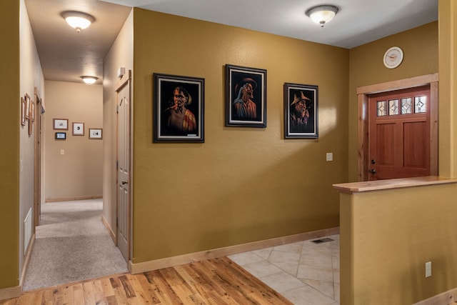 foyer entrance with light wood-type flooring