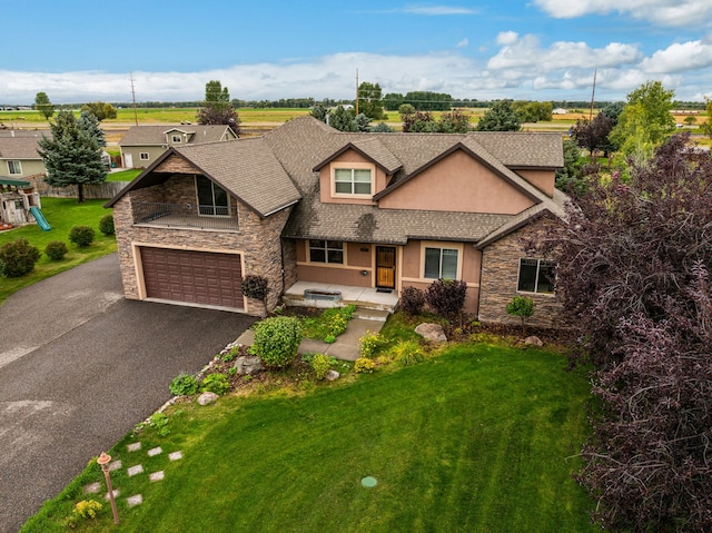 view of front of property with a front yard and a garage