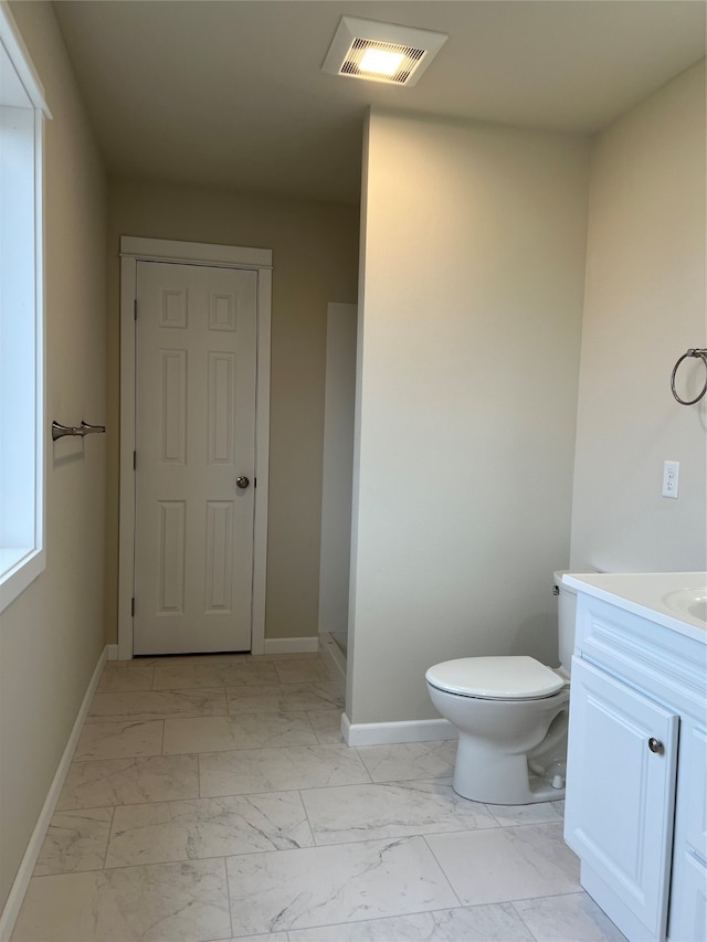 bathroom featuring vanity and toilet