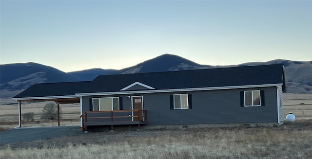 back of house featuring a mountain view and a carport