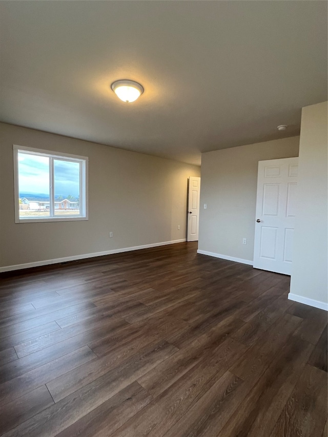 empty room featuring dark wood-type flooring