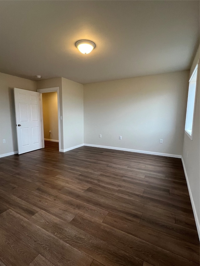 empty room featuring dark wood-type flooring