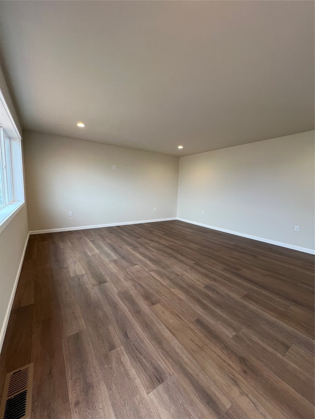 empty room with dark wood-type flooring