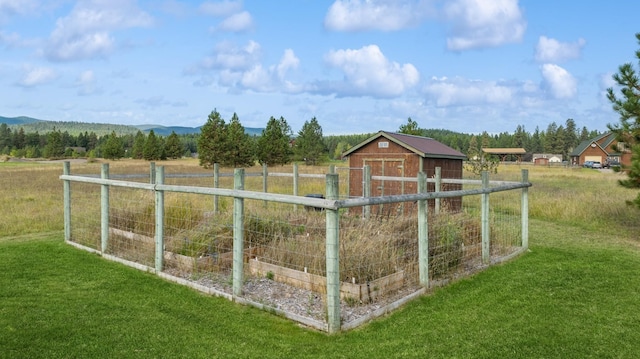 exterior space with a rural view, a mountain view, a yard, and a storage unit