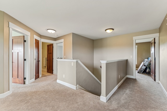 hallway featuring light carpet