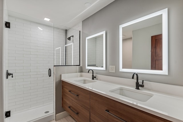 bathroom featuring vanity and a shower with door