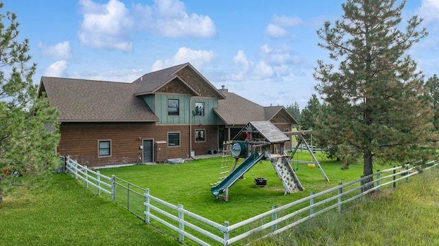 view of front of house featuring a front lawn and a playground