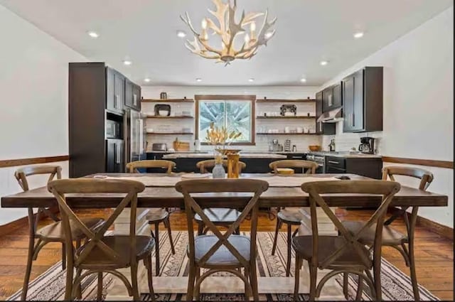 2870 US Highway 93 W, Whitefish, MT 59937 - kitchen featuring open shelves, under cabinet range hood, wood finished floors, and tasteful backsplash