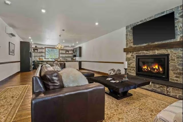 2870 US Highway 93 W, Whitefish, MT 59937 - living room with a fireplace, an AC wall unit, and hardwood / wood-style flooring