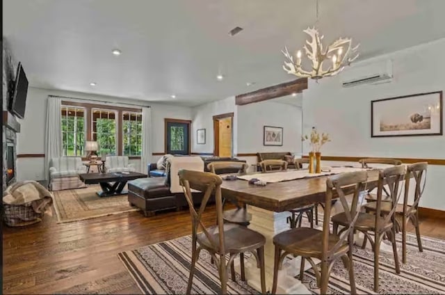 2870 US Highway 93 W, Whitefish, MT 59937 - dining space featuring a chandelier, a wall mounted AC, and hardwood / wood-style flooring