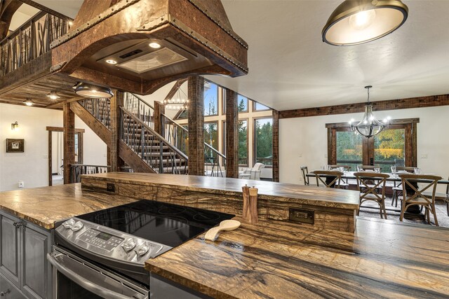 2870 US Highway 93 W, Whitefish, MT 59937 - kitchen with pendant lighting, a chandelier, electric range, and butcher block countertops