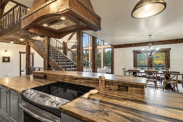 2870 US Highway 93 W, Whitefish, MT 59937 - kitchen with stainless steel electric range, a chandelier, wood counters, and pendant lighting