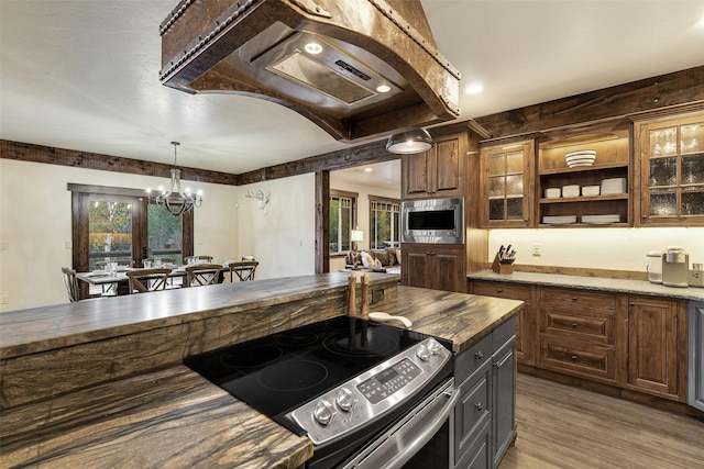 2870 US Highway 93 W, Whitefish, MT 59937 - kitchen featuring appliances with stainless steel finishes, a chandelier, glass insert cabinets, wooden counters, and light wood-style flooring
