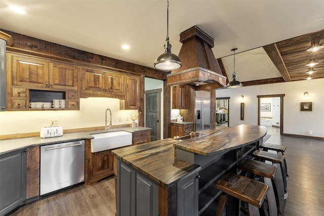 2870 US Highway 93 W, Whitefish, MT 59937 - kitchen with appliances with stainless steel finishes, dark wood-type flooring, butcher block countertops, a center island, and sink